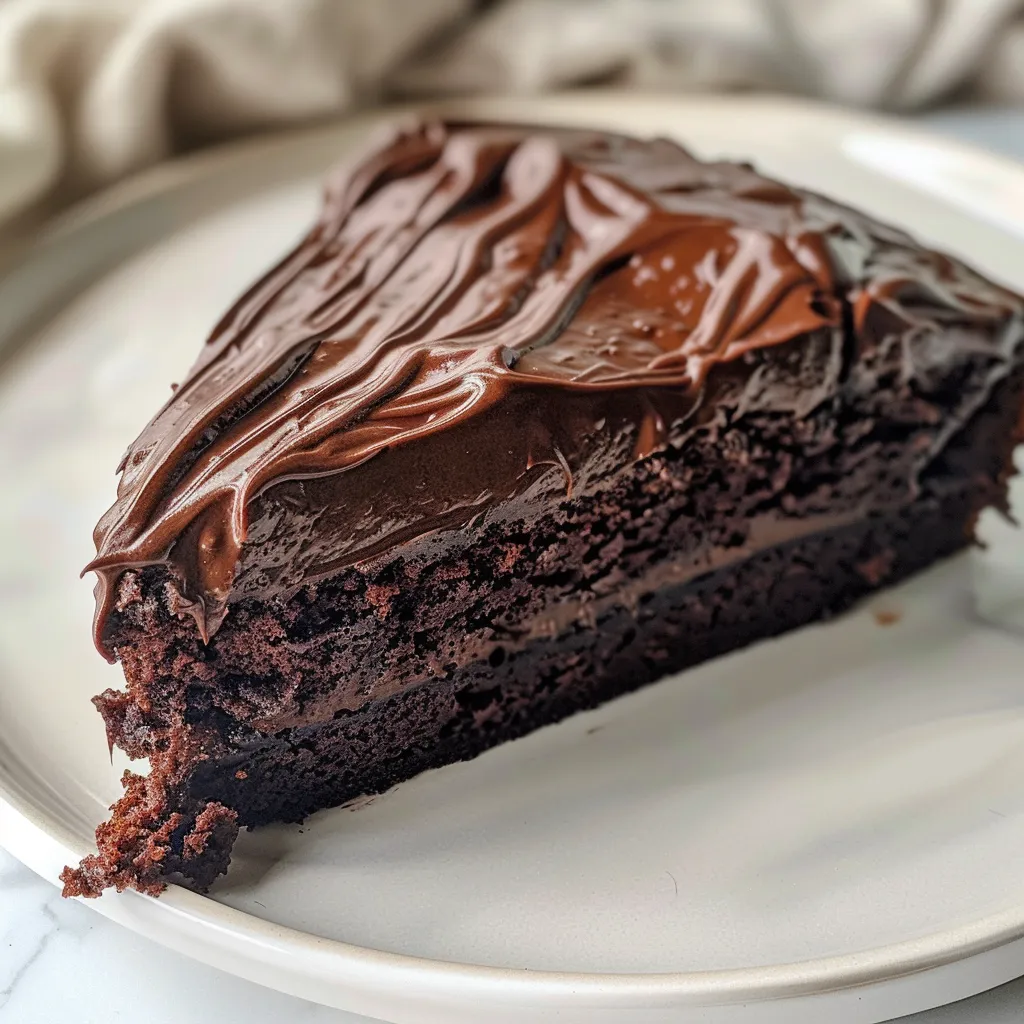 Detailed image of a moist gluten-free chocolate cake with glossy frosting.