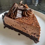 Close-up view of a luscious no-bake chocolate cheesecake with a thick crust and creamy topping.