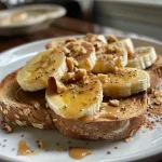 Close-up of almond butter banana toast topped with walnuts and chia seeds.