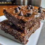 Close-up view of chocolate brownie oat breakfast bars with a rich, gooey texture.