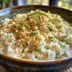 Creamy Coconut Lime Rice Pudding in a bowl with a side view showcasing its texture.