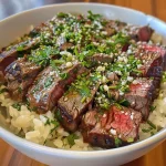 Close-up of a Beefy Garlic Butter Bowl with juicy steak cubes and rice.