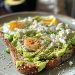 A close-up side view of Cottage Cheese Avocado Toast topped with green onions and sesame seeds.