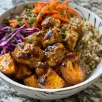 Close-up of a Hot Honey Chicken Bowl featuring diced chicken and colorful vegetables.