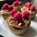 Close-up view of delicious oatmeal cups with raspberries and chocolate.