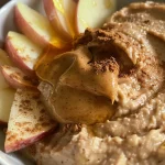 Close-up of a creamy Peanut Butter Apple Dip with sliced apples.