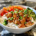 Close-up view of a Sweet Chili Chicken Rice Bowl with vibrant vegetables.