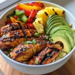 Grilled chicken and pineapple bowls with colorful vegetables and coconut rice.
