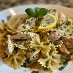Close-up view of Herby Lemon Chicken Pasta Salad with vibrant colors and fresh herbs.