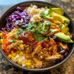 A colorful BBQ chicken bowl featuring shredded chicken, rice, corn, beans, and cheese.