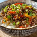 Close-up of a Beef Pepper Rice Bowl with colorful bell peppers and green onions.