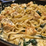 Close-up view of Chicken Spinach Alfredo Pasta in a bowl.