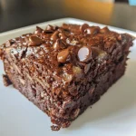 Close-up side view of a moist chocolate banana cake with chocolate chips.