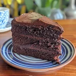 Close-up side view of a luscious chocolate fudge cake with rich frosting.