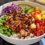 A vibrant Hawaiian Chicken Bowl featuring juicy chicken, colorful fruits, and vegetables.