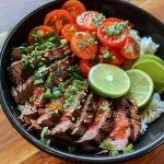 Close-up view of a healthy steak bowl with sliced steak and fresh ingredients.