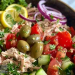 Close-up of a colorful Mediterranean Tuna Salad with vibrant ingredients.