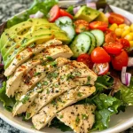 ['Close-up view of a colorful Healthy Ranch Chicken Salad with various fresh ingredients.', 'Side view of a vibrant salad featuring chicken, greens, and an array of colorful vegetables.', 'Detailed image of a healthy chicken salad with sliced avocado, tomatoes, and a creamy dressing.', 'Close-up of a nutritious ranch chicken salad showing bite-sized chicken pieces and fresh greens.']