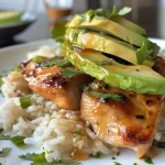 ['Close-up view of a Honey Lime Chicken and Avocado Rice Stack with vibrant colors.', 'Side view of a layered dish featuring Honey Lime Chicken, avocado slices, and rice.', 'Juicy Honey Lime Chicken stacked with rice and fresh avocado, garnished with cilantro.', 'Mouthwatering Honey Lime Chicken and Avocado Rice Stack presented on a plate.']