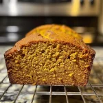 ['Close-up view of a slice of moist Butternut Squash Bread with a golden-brown crust.', 'Side angle of Butternut Squash Bread, showcasing its soft, spiced texture.', 'Detailed image of a freshly baked Butternut Squash Bread, highlighting its rich color and ingredients.', 'Juicy, sliced Butternut Squash Bread with visible spices and a fluffy interior.']