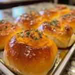 ['A close-up side view of golden-brown butternut squash dinner rolls, soft and fluffy.', 'Juicy, freshly baked butternut squash dinner rolls arranged neatly on a plate, showing their texture.', 'A detailed view of warm, inviting butternut squash dinner rolls with a golden crust and rosemary sprinkles.', 'Soft and pillowy butternut squash dinner rolls captured in a side view, highlighting their deliciousness.']