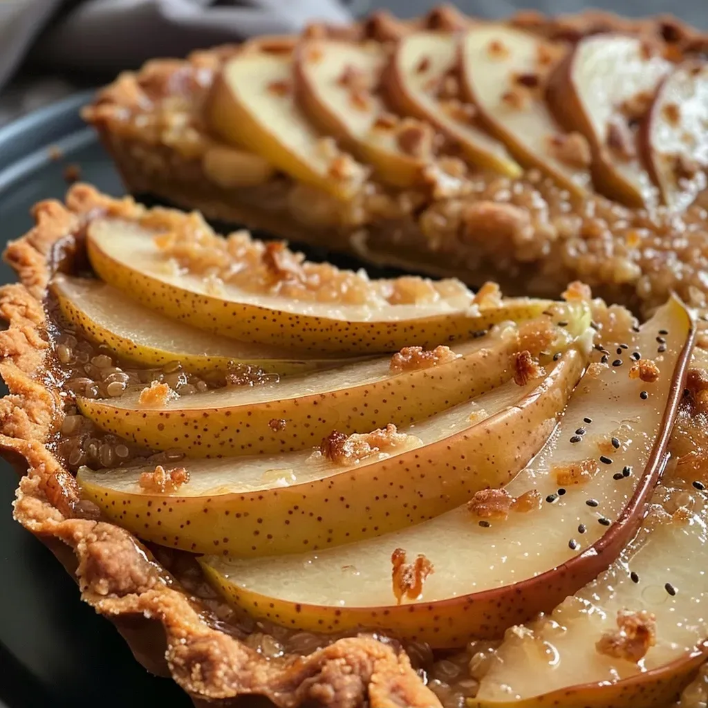 ['Close-up side view of a gingery pear tart with a golden crust and sliced pears on top.', 'Juicy vegan and gluten-free pear tart featuring a flaky crust and pear slices, captured with an iPhone.', 'Side view of a delicious gingery pear tart showcasing a textured crust and fresh pear filling.', 'Zoomed-in shot of a vegan gingery pear tart, highlighting the juicy pear slices and flaky pastry.']