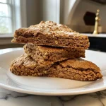 ['Close-up view of golden-brown Spiced Molasses Scones with a crumbly texture.', 'Side view of freshly baked Spiced Molasses Scones showcasing a warm, inviting color.', 'Deliciously spiced scones with a glossy finish from molasses, displayed on a rustic surface.', 'A detailed look at Spiced Molasses Scones, highlighting their soft, inviting interior.']