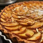['A close-up side view of a spiced pear and almond tart on a wooden table.', 'A detailed shot showcasing the layers of a spiced pear and almond tart with golden crust and juicy pears.', 'Close-up of a beautifully baked spiced pear almond tart with a flaky texture and garnished with pear slices.', 'A delectable side view of a spiced pear and almond tart highlighting its rich filling and vibrant color.']