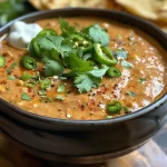 ['A close-up side view of a creamy Tikka Masala Dip served in a bowl.', 'A vibrant Tikka Masala Dip featuring spices and garnishes in a dish.', 'A detailed image of Tikka Masala Dip displaying its rich, creamy texture.', 'A side angle view of a colorful Tikka Masala Dip, showcasing its ingredients and garnishes.']