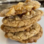 ['Close-up view of freshly baked apple and honey cookies with a golden-brown crust.', 'Side view of apple and honey cookies adorned with colorful sugar sprinkles.', 'Juicy apple and honey cookies with a glossy icing, captured in vibrant detail.', 'Delicious apple and honey cookies featuring a textured surface and bright decorations.']