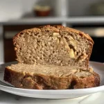 ['Close-up view of freshly baked apple cider bread with a golden crust.', 'Side view of apple cider bread showcasing its moist texture and apple chunks.', 'Detailed shot of apple cider bread emphasizing its warm, inviting appearance.', 'Slice of apple cider bread with visible spices and apple pieces, highlighting its homemade quality.']