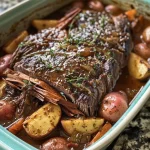['Close-up of a juicy Apple Cider Pot Roast with herbs and vegetables.', 'Side view of a mouthwatering Apple Cider Pot Roast on a rustic plate.', 'Detailed image of a savory Apple Cider Pot Roast garnished with fresh herbs.', 'Luscious Apple Cider Pot Roast with chunks of apple and spices visible.']
