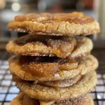 ['Close-up of freshly baked apple pie cookies with a golden-brown crust.', 'Side view of apple pie cookies showcasing juicy apple pieces and a rustic texture.', 'Delicious apple pie cookies with a crispy exterior and visible chunks of apples.', 'Tasty apple pie cookies displayed on a white plate, highlighting their warm color.']