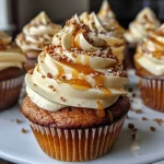 ['Brown Butter Pumpkin Caramel Latte Cupcakes with swirls of caramel frosting.', 'Close-up of a moist Brown Butter Pumpkin Caramel Latte Cupcake showcasing its rich colors.', 'Side view of a cupcake topped with caramel and decorated with pumpkin spice elements.', 'Beautifully presented Brown Butter Pumpkin Caramel Latte Cupcakes with a glossy caramel drizzle.']