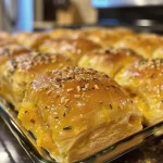 ['Close-up side view of warm Butternut Squash Dinner Rolls on a wooden surface.', 'Soft and fluffy Butternut Squash Dinner Rolls arranged on a rustic table.', 'Freshly baked Butternut Squash Dinner Rolls with a golden crust and soft interior.', 'A tempting display of Butternut Squash Dinner Rolls, showcasing their texture and color.']