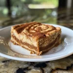 ['A close-up side view of a moist Cinnamon Swirl Protein Cake with a golden-brown top.', 'A slice of Cinnamon Swirl Protein Cake showcasing its swirled cinnamon filling and textured appearance.', 'An iPhone photo of a delectable Cinnamon Swirl Protein Cake emphasizing its juiciness and fluffy texture.', 'A side view of a perfectly baked Cinnamon Swirl Protein Cake highlighting its cinnamon swirls and soft crust.']