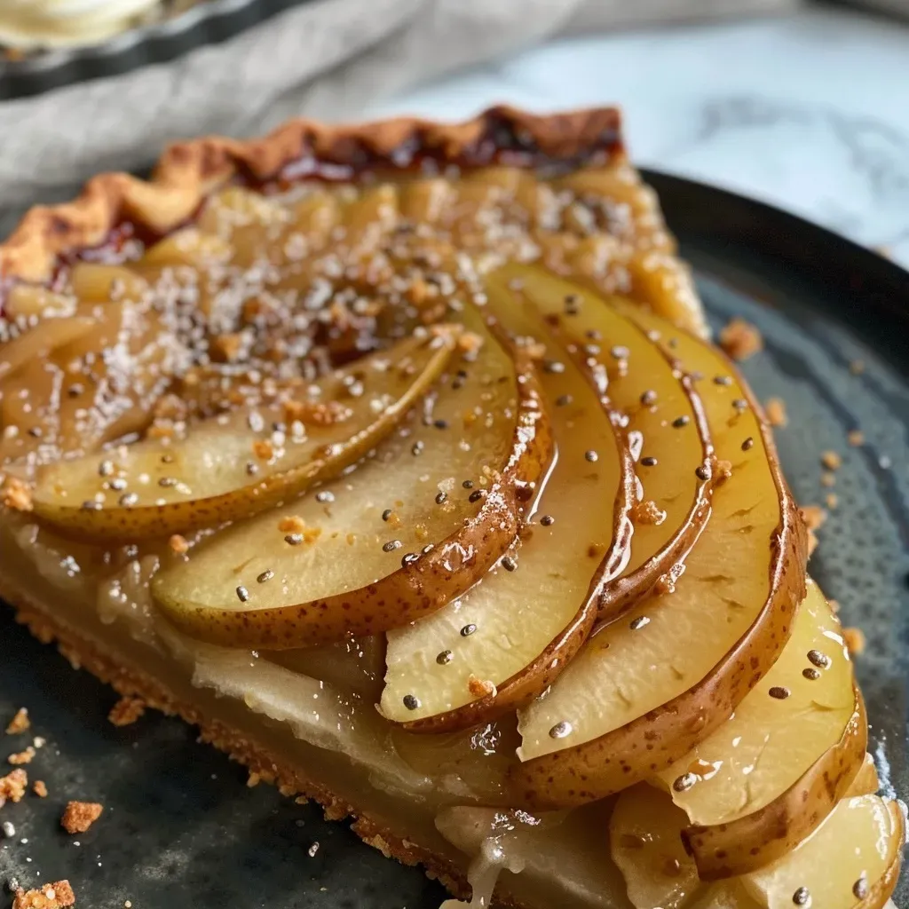 ['Close-up side view of a vegan and gluten-free Gingery Pear Tart with a golden crust.', 'Juicy slices of ginger-infused pear arranged on a tart, showcasing a flaky crust and rich filling.', 'A vibrant, side view of a Gingery Pear Tart highlighting ripe pear slices and a buttery appearance.', 'Close-up detail of a delicious pear tart topped with coconut whipped cream, set against a simple background.']