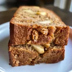 ['A slice of healthy apple bread with whole wheat and honey, showcasing its moist texture and apple pieces.', 'Close-up of a freshly baked healthy apple bread, highlighting its golden crust and soft interior with grated apples.', 'Side view of healthy apple bread on a wooden cutting board, with visible ingredients like nuts and cinnamon on top.', 'A delicious serving of healthy apple bread, revealing its fluffy texture and bits of apple throughout.']