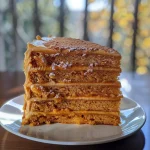 ['A close-up side view of a layered sweet potato cake with creamy frosting.', 'Side view of a moist sweet potato layer cake displaying its rich, fluffy layers.', 'A detailed side angle of a sweet potato cake with visible layers and smooth icing.', 'Close-up of a sweet potato layer cake showcasing the texture and frosting.']